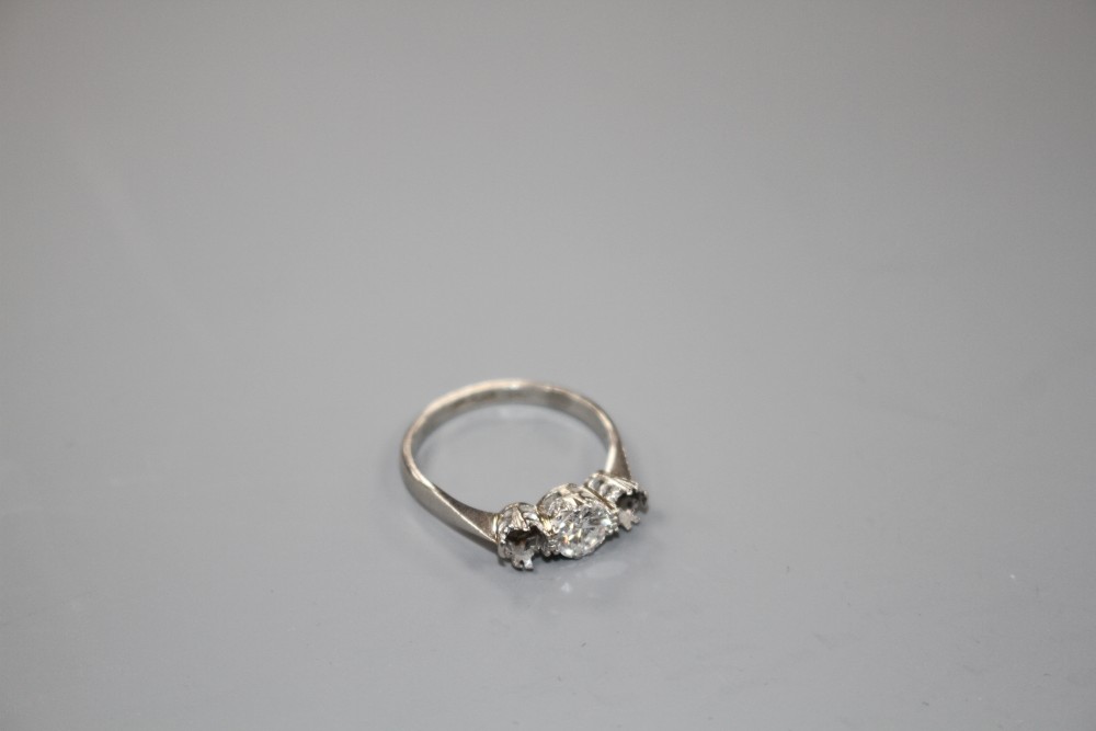 A white metal and single stone (ex three stone) diamond ring,
